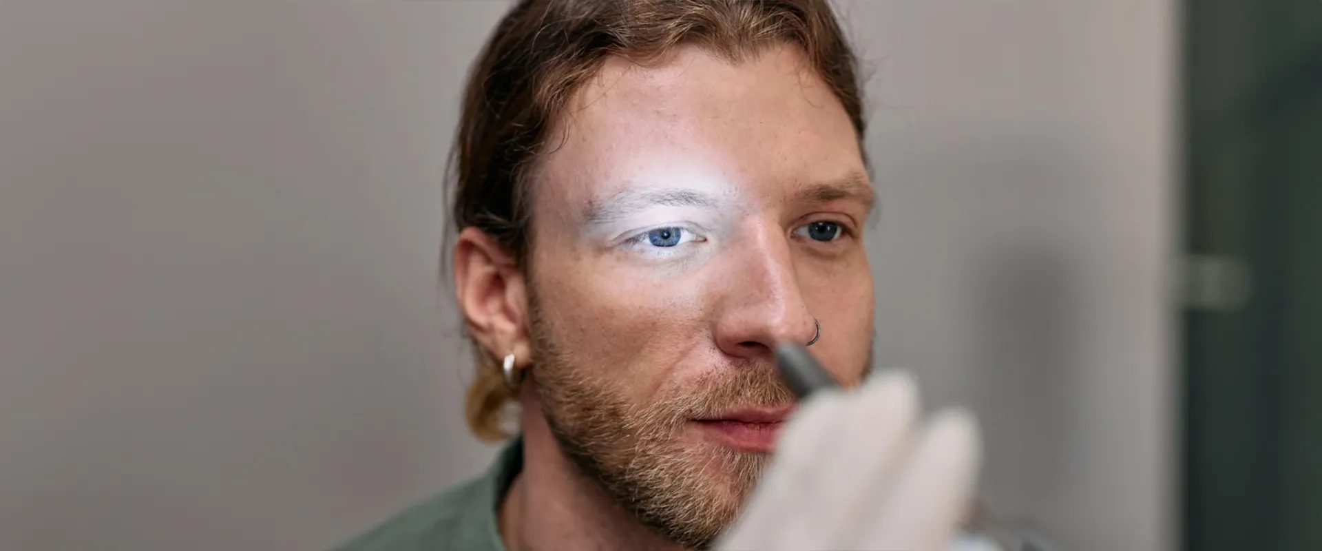 A photo of a man getting his eyes checked.