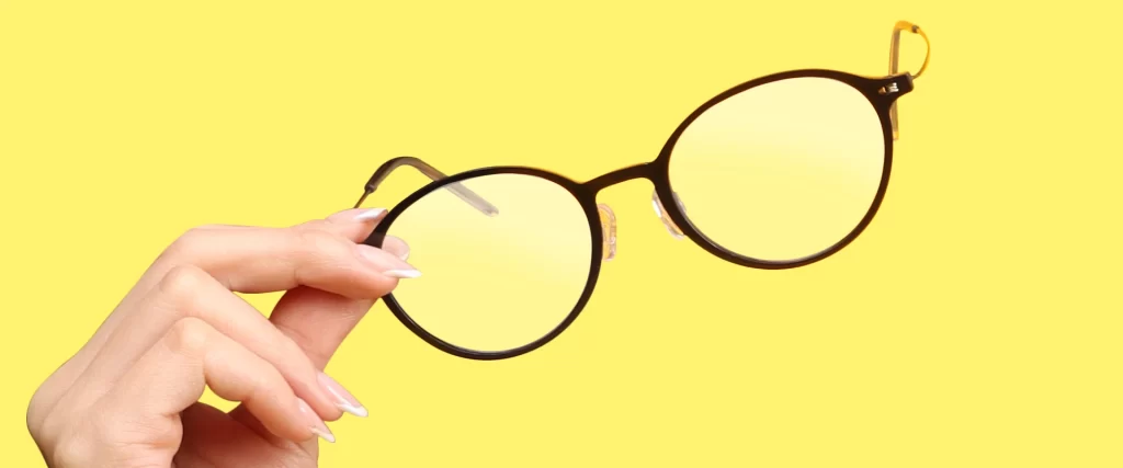 Hand Holding Eyeglasses - Can Glasses Protect Your Vision